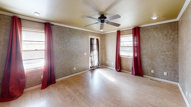 spare room with ceiling fan, light wood-type flooring, and crown molding