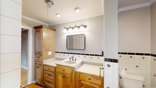 bathroom with hardwood / wood-style flooring, toilet, tile walls, and ornamental molding