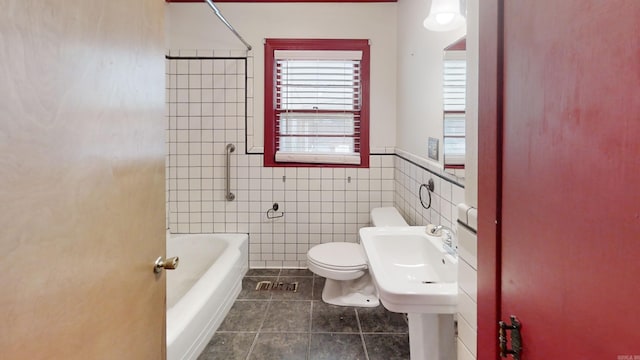 bathroom with  shower combination, tile patterned flooring, tile walls, and toilet