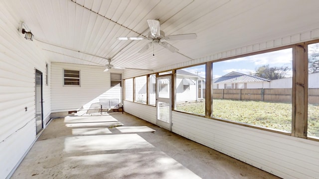 unfurnished sunroom with ceiling fan