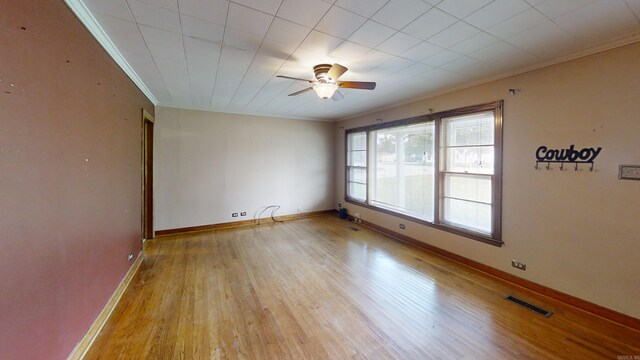 spare room featuring light hardwood / wood-style flooring, ceiling fan, and ornamental molding