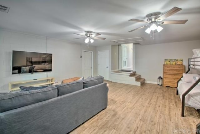 living room featuring ceiling fan and light hardwood / wood-style flooring