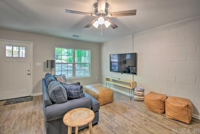 living room with ceiling fan and hardwood / wood-style flooring
