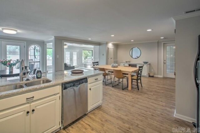 kitchen with dishwasher, sink, a wealth of natural light, and light hardwood / wood-style flooring