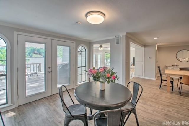 dining room with french doors, light wood-type flooring, and plenty of natural light