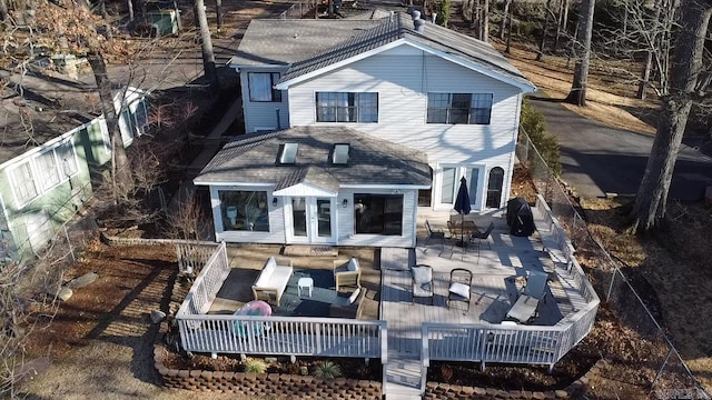 back of house with outdoor lounge area, french doors, and a wooden deck