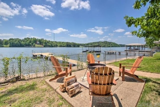view of patio / terrace with a water view and a dock
