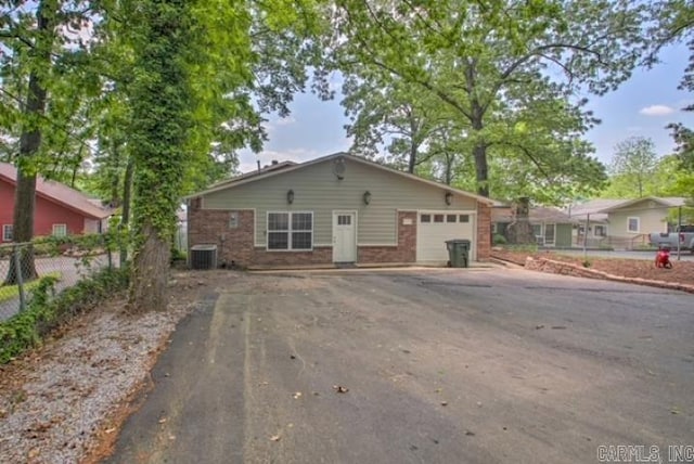 view of front of home featuring central AC and a garage
