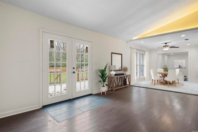 doorway with dark hardwood / wood-style floors, a healthy amount of sunlight, lofted ceiling, and french doors