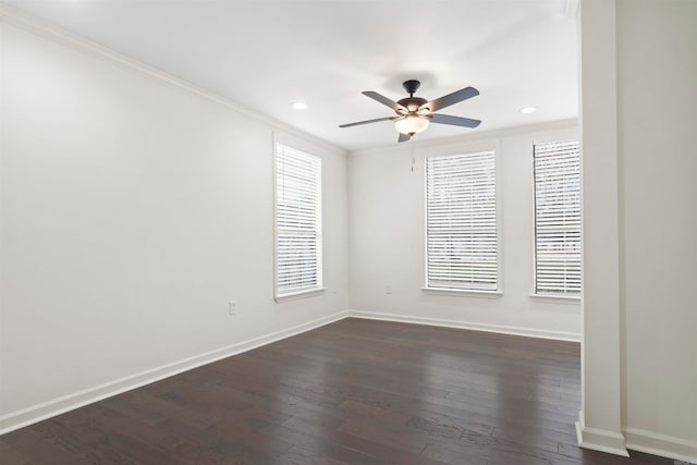 spare room with plenty of natural light, dark hardwood / wood-style floors, and crown molding