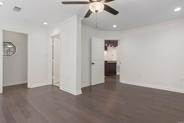 empty room featuring ceiling fan, dark hardwood / wood-style flooring, and ornamental molding