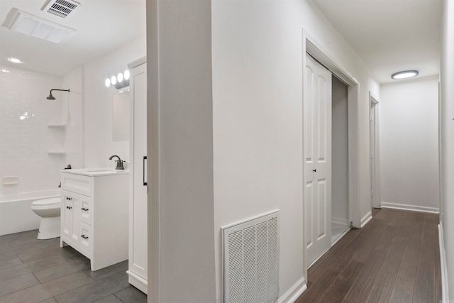 corridor featuring dark hardwood / wood-style floors and sink