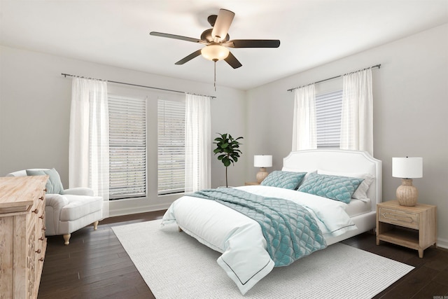 bedroom with dark hardwood / wood-style flooring, multiple windows, and ceiling fan