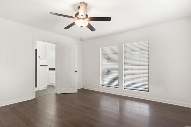 empty room featuring ceiling fan and dark wood-type flooring