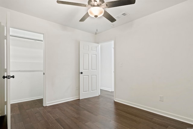 unfurnished bedroom with ceiling fan, dark hardwood / wood-style floors, and a closet