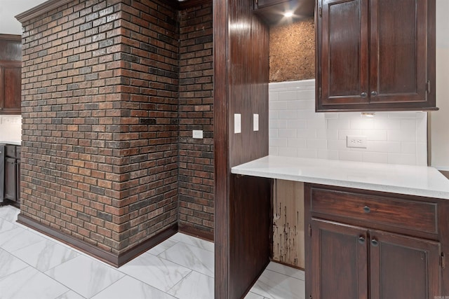 kitchen featuring dark brown cabinets and tasteful backsplash