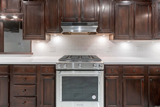 kitchen featuring dark brown cabinetry, stainless steel range, and tasteful backsplash