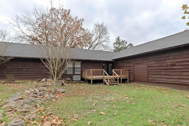 rear view of house featuring central AC, a yard, and a deck