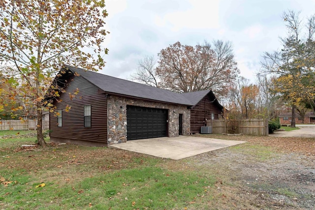 view of home's exterior featuring a garage and central air condition unit