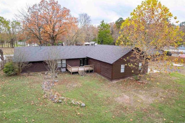 back of house featuring a deck and a yard