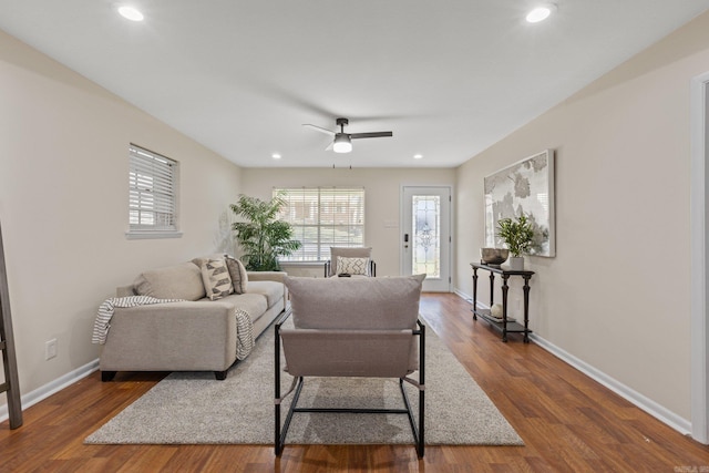 living room featuring dark hardwood / wood-style floors and ceiling fan