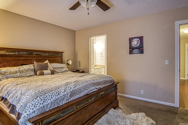 carpeted bedroom featuring ensuite bathroom, ceiling fan, and a textured ceiling