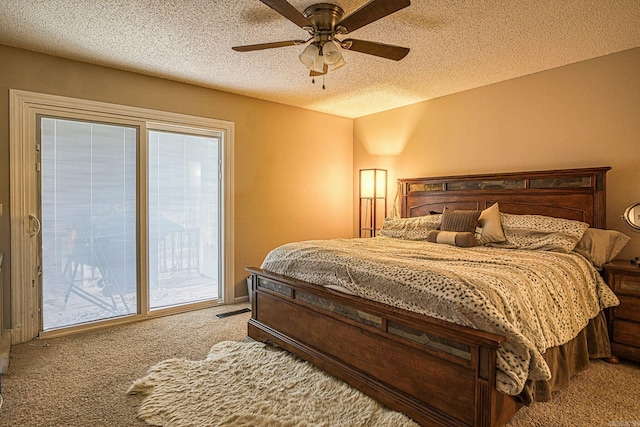 bedroom featuring access to exterior, a textured ceiling, carpet floors, and ceiling fan