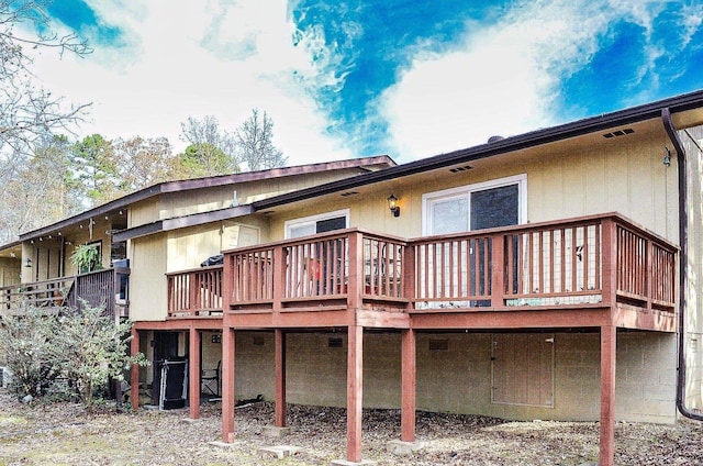 rear view of property with a wooden deck