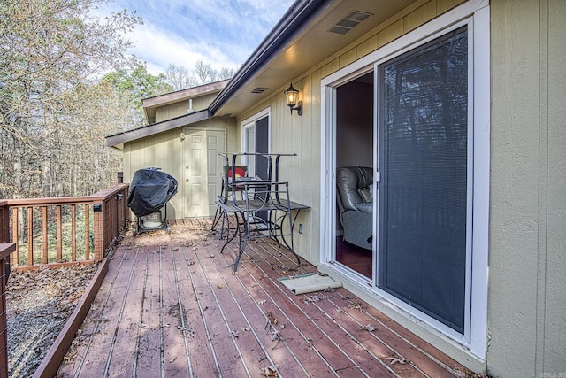 wooden terrace featuring grilling area