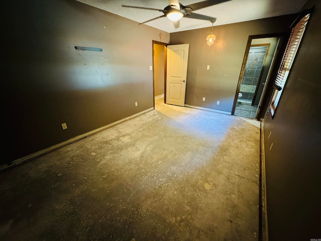 unfurnished bedroom featuring ceiling fan, concrete flooring, and a textured ceiling