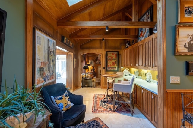 sitting room featuring light tile patterned flooring, vaulted ceiling with beams, wooden walls, and wood ceiling