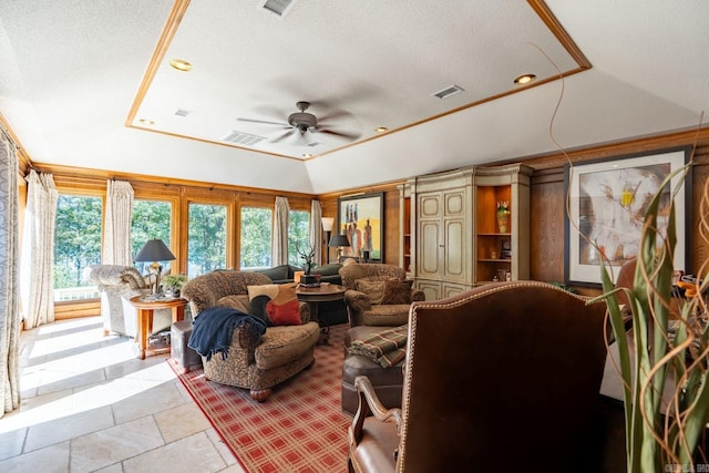 living room featuring ceiling fan, a textured ceiling, and vaulted ceiling