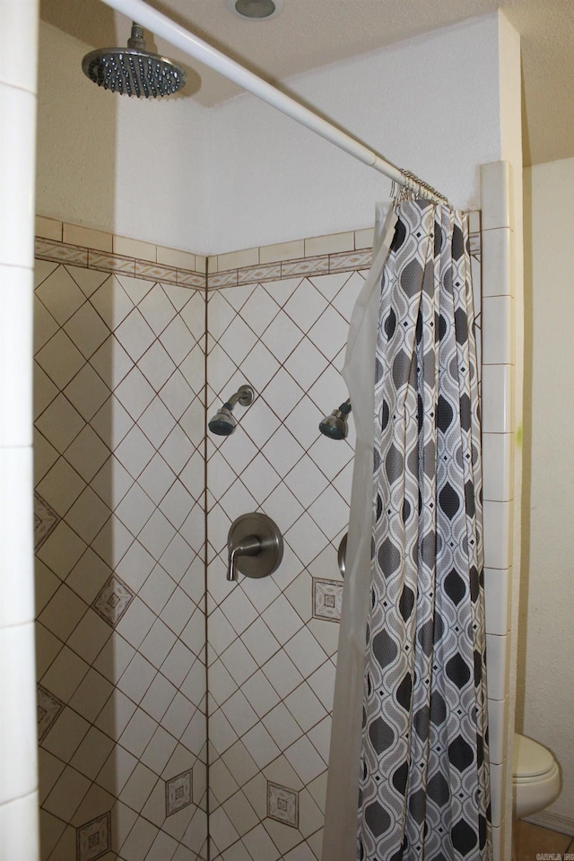 bathroom with toilet and walk in shower