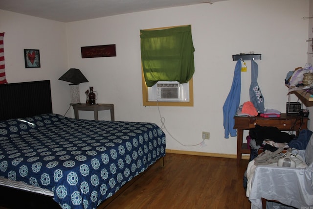 bedroom with dark hardwood / wood-style flooring and cooling unit