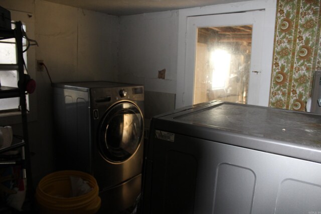 clothes washing area featuring independent washer and dryer