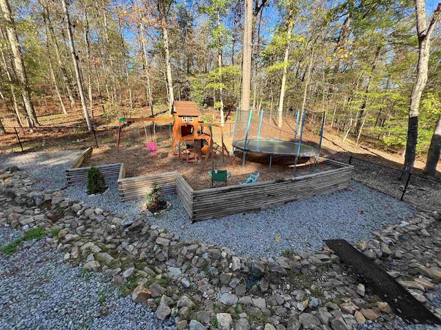 view of yard with a playground and a trampoline