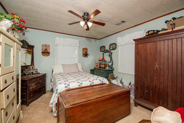 carpeted bedroom featuring a textured ceiling, ceiling fan, and crown molding