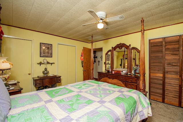 bedroom featuring ceiling fan, carpet, and two closets