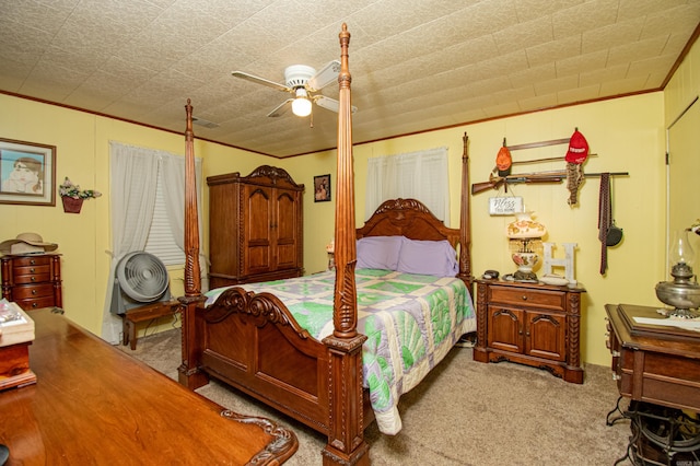 carpeted bedroom featuring ceiling fan and ornamental molding