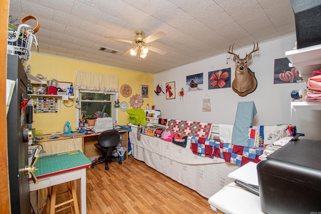 recreation room with ceiling fan and hardwood / wood-style flooring