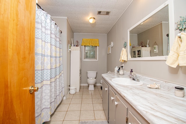 bathroom with tile patterned flooring, vanity, toilet, and ornamental molding