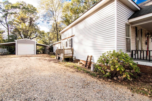 view of side of home with an outbuilding, a garage, and a carport