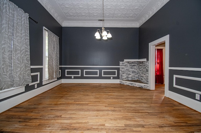 unfurnished dining area featuring hardwood / wood-style flooring and a chandelier