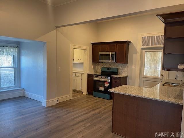 1905 Bethesda, Mena, AR 71953 - kitchen featuring appliances with stainless steel finishes, open shelves, dark wood-style floors, light stone countertops, and baseboards