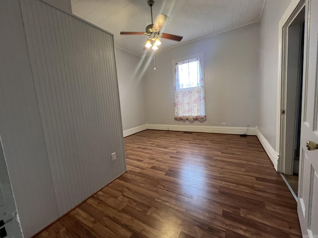 1905 Bethesda, Mena, AR 71953 - unfurnished room with dark wood-style flooring, a ceiling fan, ornamental molding, and baseboards