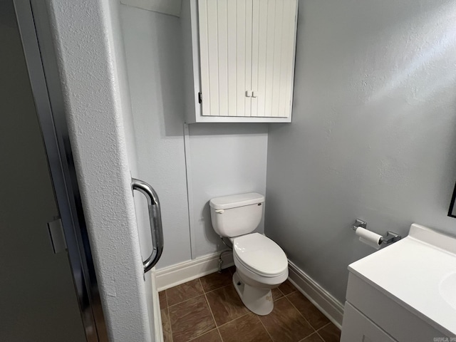 1905 Bethesda, Mena, AR 71953 - bathroom with toilet, vanity, baseboards, and tile patterned floors