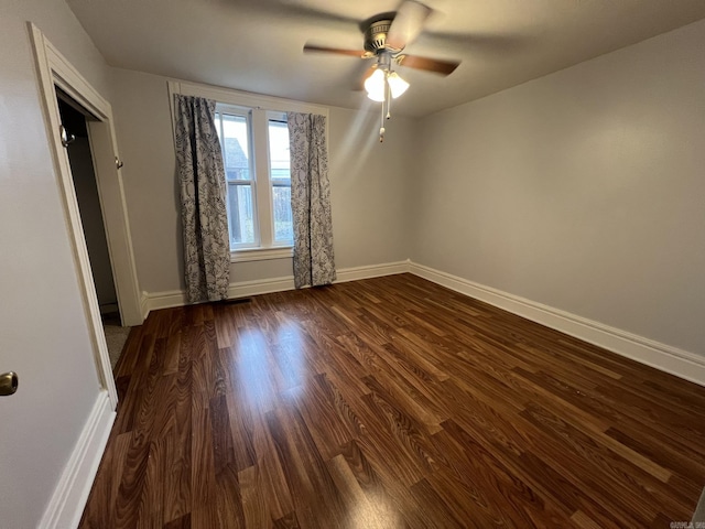 1905 Bethesda, Mena, AR 71953 - spare room with a ceiling fan, dark wood-style flooring, and baseboards