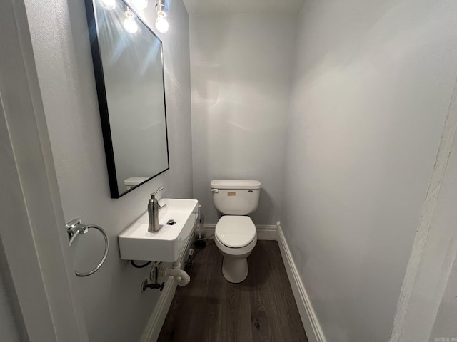 1905 Bethesda, Mena, AR 71953 - half bathroom featuring wood finished floors, toilet, a sink, and baseboards