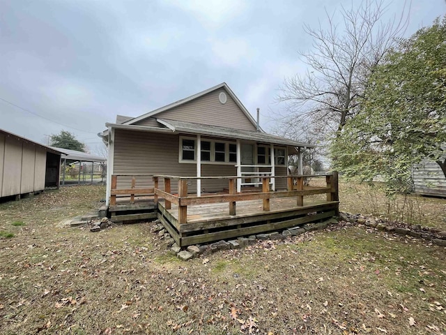 rear view of property featuring a deck