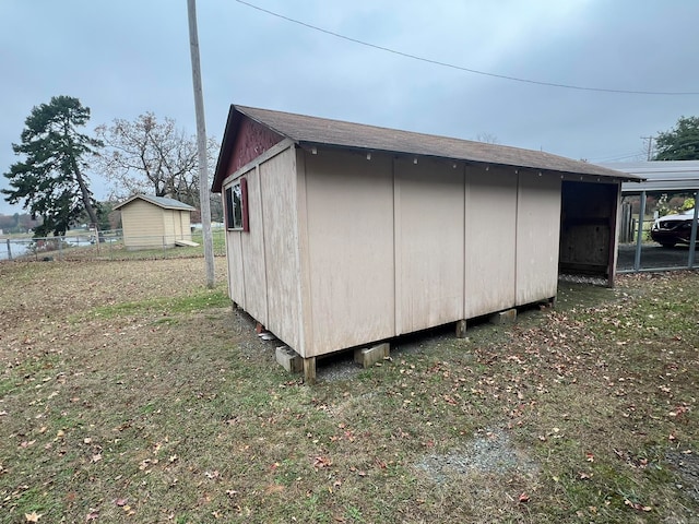 view of shed featuring fence